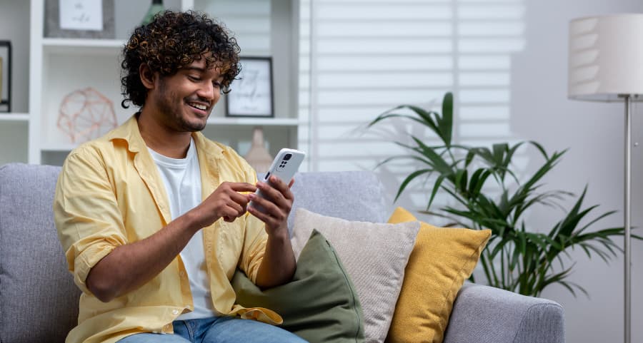 Resident accessing a home security app on his mobile device